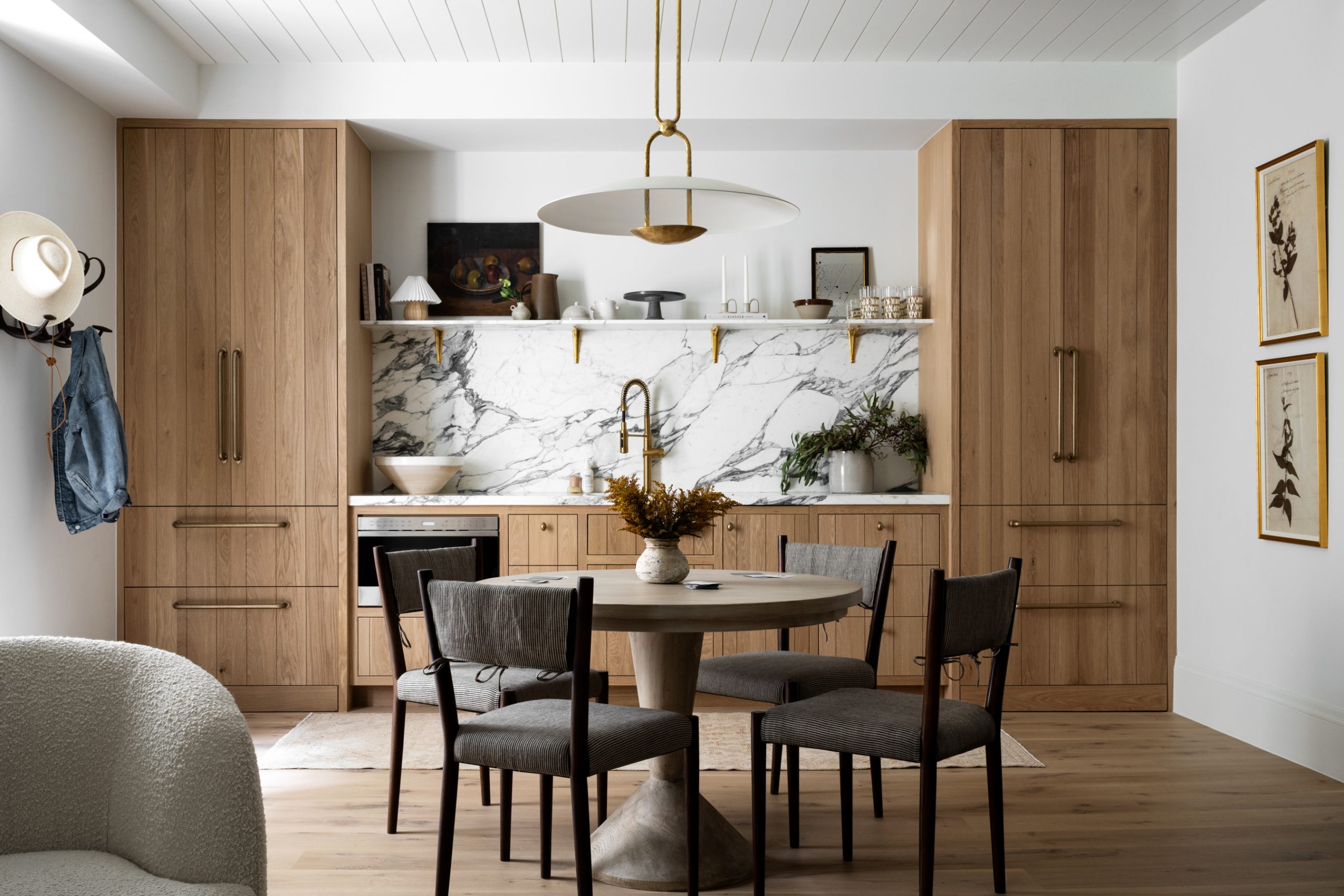 kitchenette with wood cabinets and marble countertop and back splash