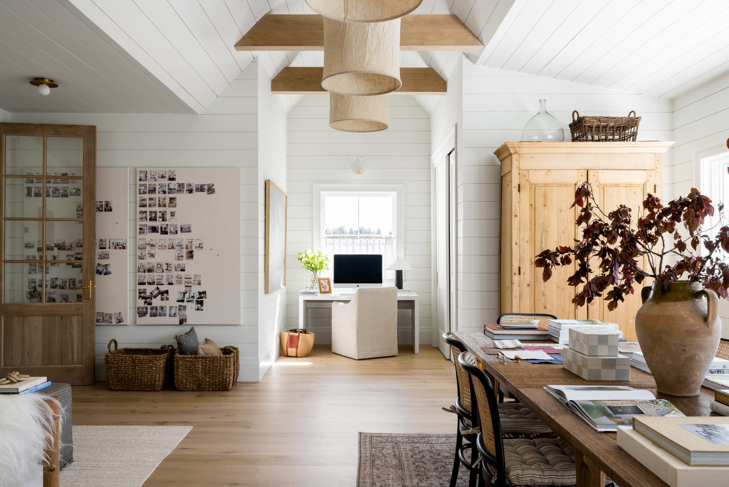 studio with pin boards, desk, table, cabinet, and sofa