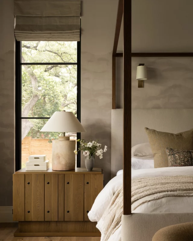 Cozy starts with layers. In the primary bedroom of our Oaks Project, we mixed soft linens, warm woods, and subtle textures to create a space that feels both relaxed and refined. Learn more at our link in bio.